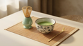 Wrenly matcha ritual set with floral ceramic bowl of whisked matcha, bamboo whisk, celadon whisk holder and bamboo scoop